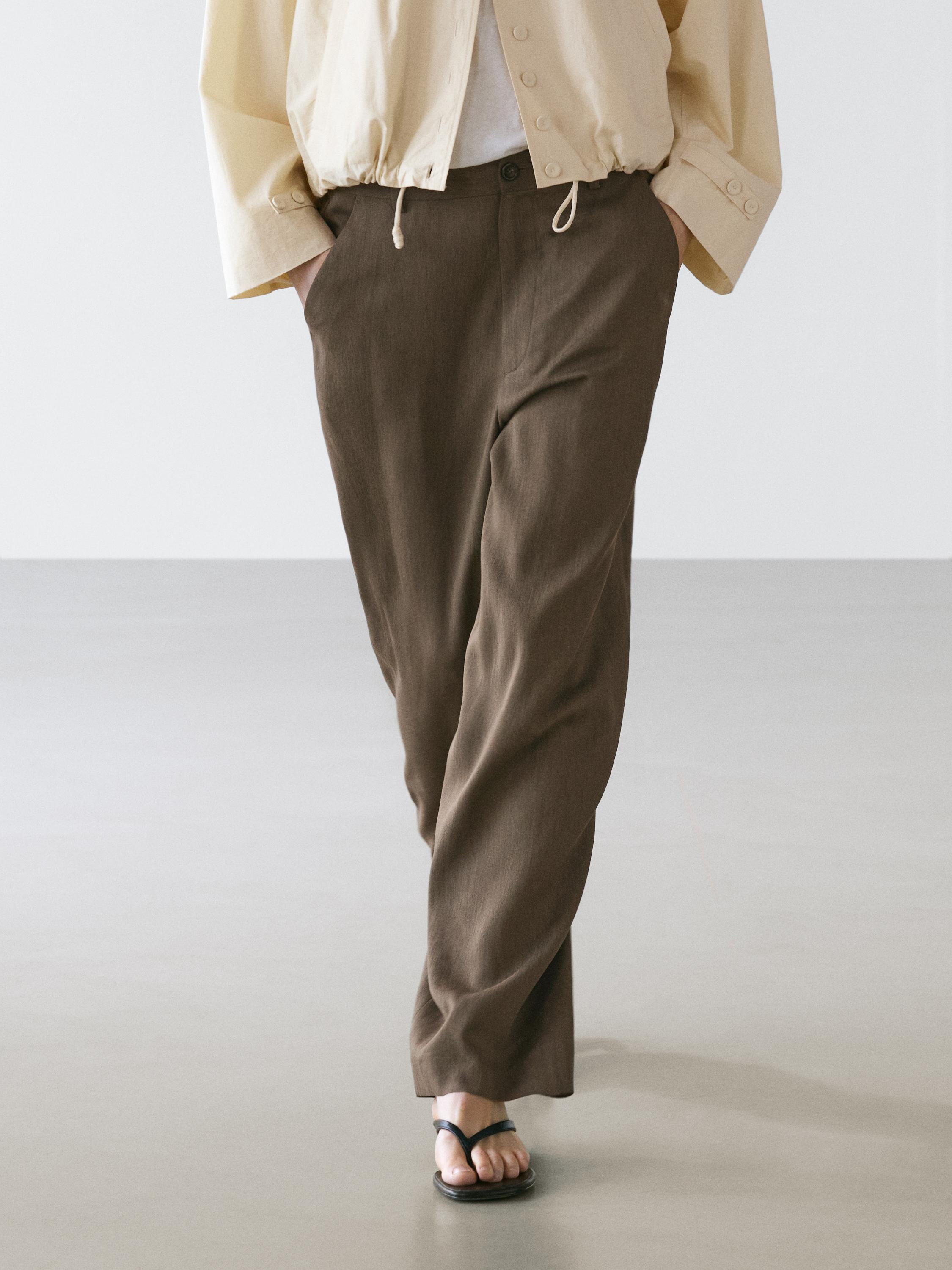 Flowing trousers with elasticated waistband